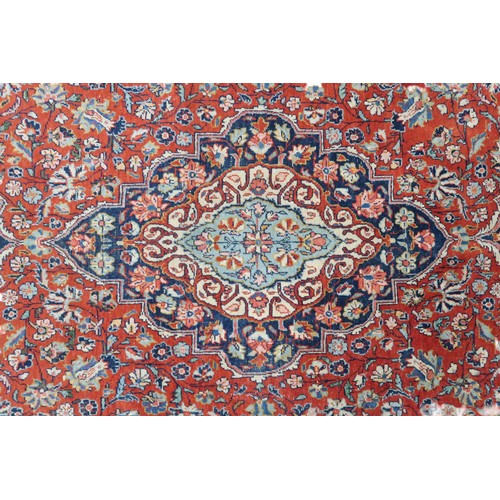 2160 - A RED GROUND FINE PILE ISFAHAN RUG with dark blue and cream central medallion and matching span... 