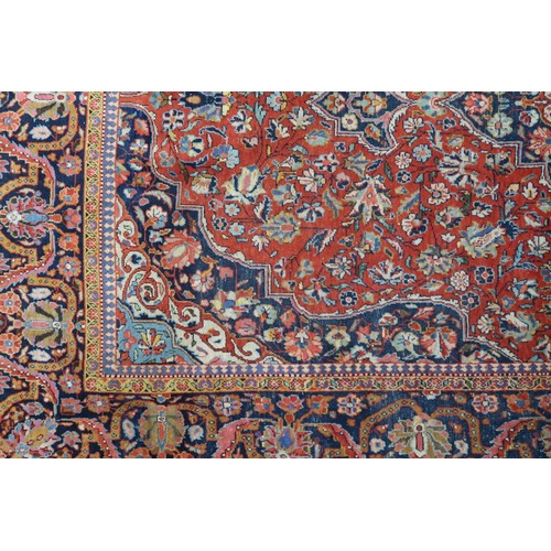 2160 - A RED GROUND FINE PILE ISFAHAN RUG with dark blue and cream central medallion and matching span... 