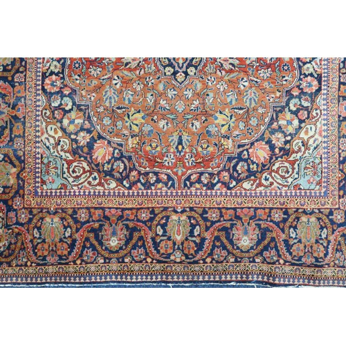 2160 - A RED GROUND FINE PILE ISFAHAN RUG with dark blue and cream central medallion and matching span... 