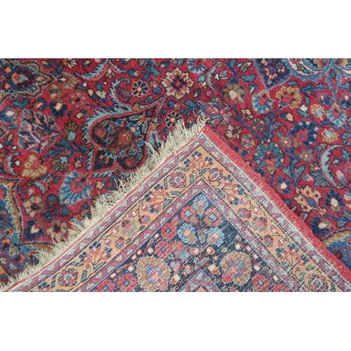 2161 - A RED GROUND FINE PILE NAIN RUGwith blue and cream sunburst medallion and blue spandrels on multicol... 