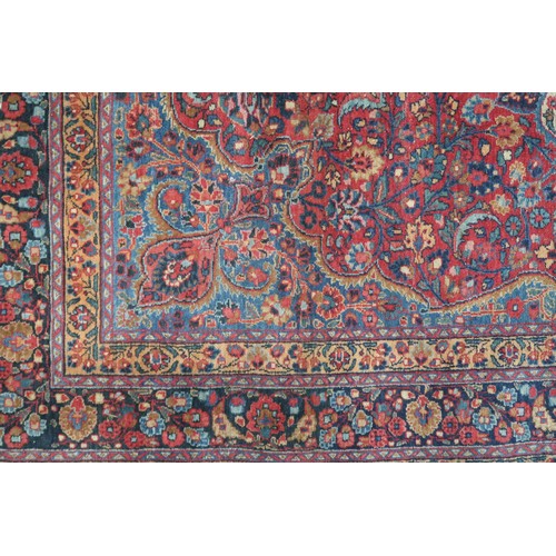 2161 - A RED GROUND FINE PILE NAIN RUGwith blue and cream sunburst medallion and blue spandrels on multicol... 