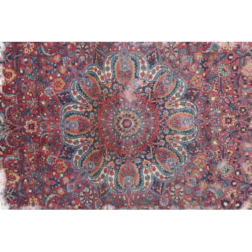 2161 - A RED GROUND FINE PILE NAIN RUGwith blue and cream sunburst medallion and blue spandrels on multicol... 