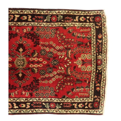 2162 - A RED GROUND IRANIAN KARAJEH RUNNERwith multicoloured geometric floral/foliate patterned ground with... 