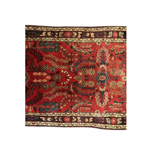 2162 - A RED GROUND IRANIAN KARAJEH RUNNERwith multicoloured geometric floral/foliate patterned ground with... 