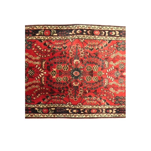 2162 - A RED GROUND IRANIAN KARAJEH RUNNERwith multicoloured geometric floral/foliate patterned ground with... 