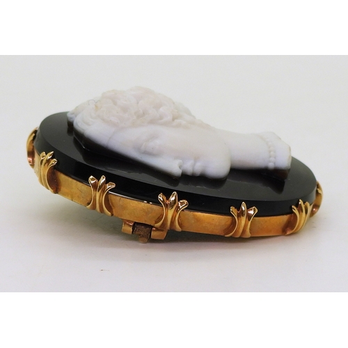 2823 - AN AGATE CAMEOcarved from black and white agate, the detailed cameo of a maiden, is set in a bright ... 