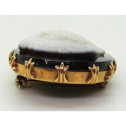 2823 - AN AGATE CAMEOcarved from black and white agate, the detailed cameo of a maiden, is set in a bright ... 