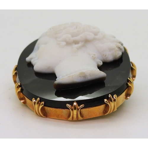 2823 - AN AGATE CAMEOcarved from black and white agate, the detailed cameo of a maiden, is set in a bright ... 