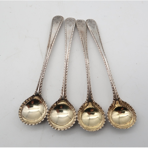 268D - A collection of flatware including a pair of Georgian silver sugar tongs, four Old English feathered... 