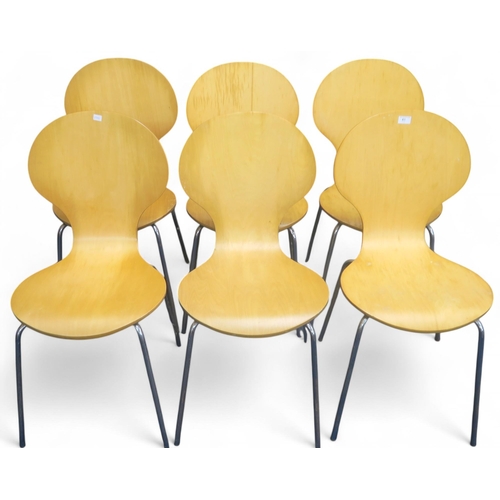 61 - A set of six 20th century after Arne Jacobsen laminated bentwood stacking dining chairs on chromed s... 