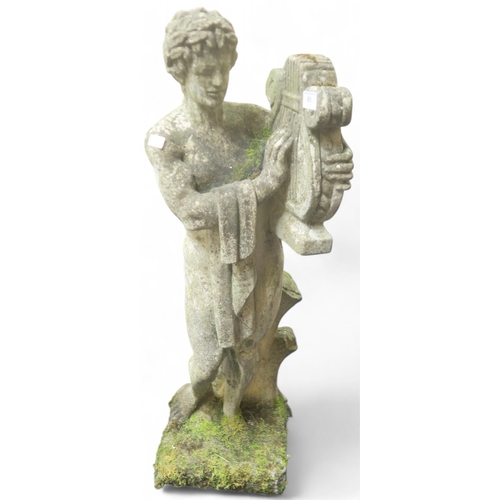 63 - A 20th century reconstituted stone garden statue modelled as a classical male nude playing a lyre, 8... 