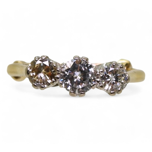 774 - A three stone diamond ring, made in bright yellow metal set with estimated approx 1ct in total of br... 