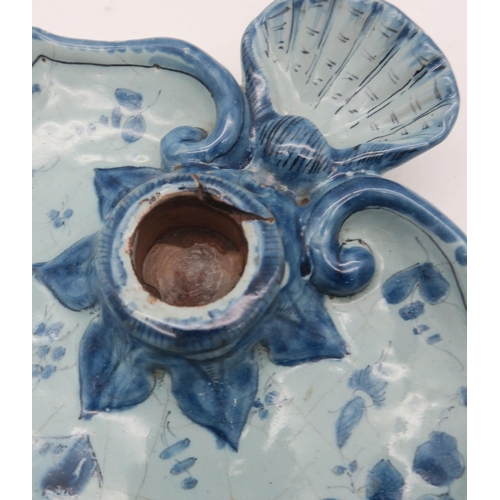 136 - A Cantagalli faience blue and white candlestick, with shell shaped handle and painted with a house i... 