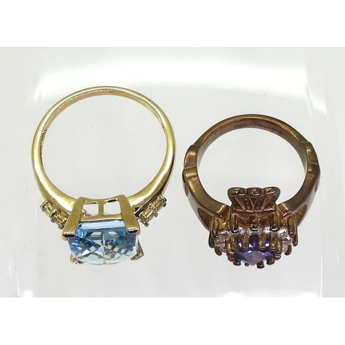 709 - Two 9ct gold rings, a clear and purple cz set Claddagh ring, size J, a chequer board cut blue topaz ... 