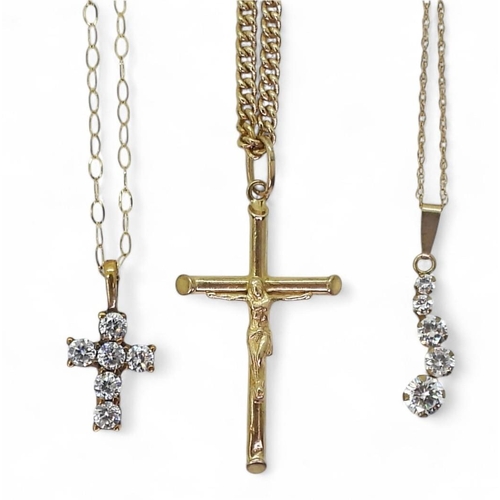 766 - Two 9ct gold cz set pendants, and a 9ct gold crucifix with a gold plated chain. Weight combined 2.5g... 