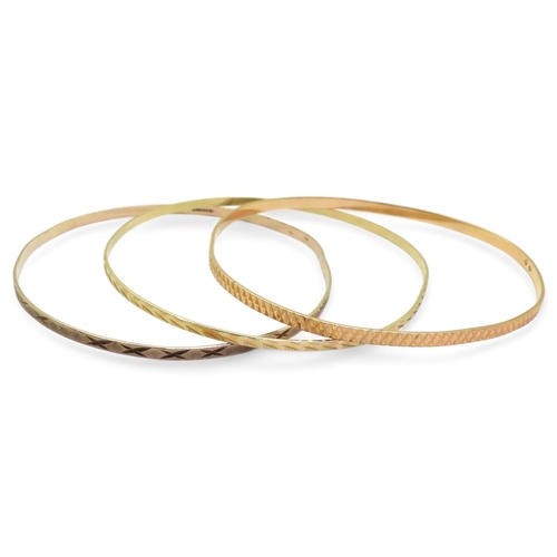 793 - Three 9ct bangles, one stamped 9ct the other two with French weevil hallmarks weight together 13.2gm... 