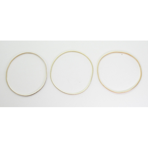 793 - Three 9ct bangles, one stamped 9ct the other two with French weevil hallmarks weight together 13.2gm... 