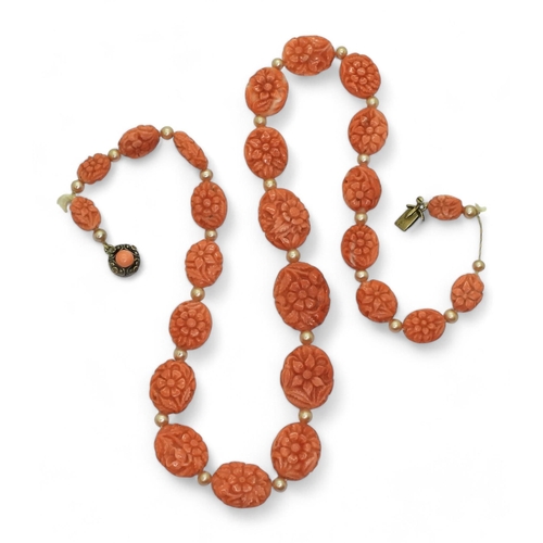 796 - A string of nicely carved coral beads each carved with flowers tapering in size from 17.6mm x 13.9mm... 