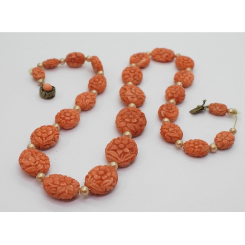 796 - A string of nicely carved coral beads each carved with flowers tapering in size from 17.6mm x 13.9mm... 