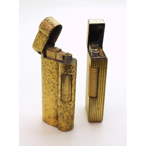 850 - Two gold plated vintage Dunhill lighters, together with a collection of silver and white metal chain... 