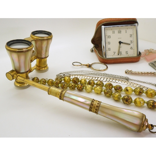 864 - A  pair of gold-plated mother-of-pearl opera glasses, together with a portable clock marked Smiths j... 