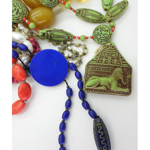 872 - Two Egyptian-themed beaded necklaces made by Max Neiger (af), one blue and one green, together with ... 