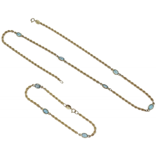 765 - A 46cm 9ct gold rope chain set with blue topaz along its length, with a matching bracelet, weight to... 