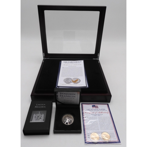 367 - The Fabulous 12 US Silver Dollar Collection. Twelve silver and gold plated coins in a presentation b... 