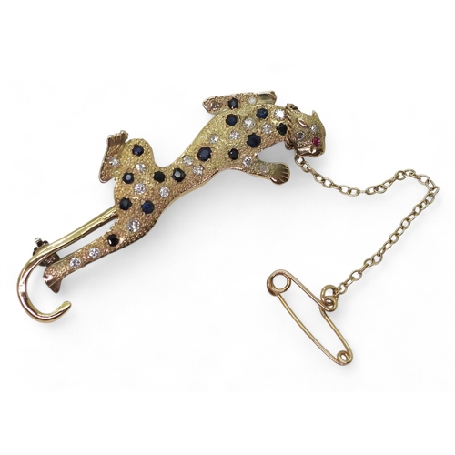 757 - A leopard brooch, the bright yellow textured body is set with sapphires and diamonds, with a ruby se... 