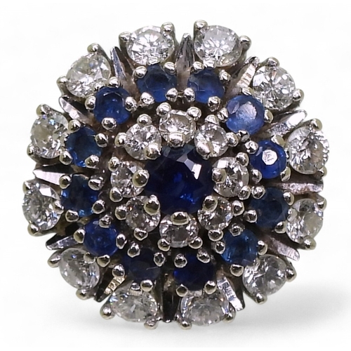 765 - A sapphire & diamond ring, the classic cluster is mounted in 14k white gold, with a star burst d... 