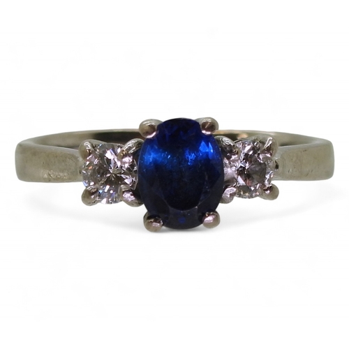 2714 - A SAPPHIRE & DIAMOND THREE STONEset in 18ct white gold the central sapphire is approx 7mm x 5.4m... 