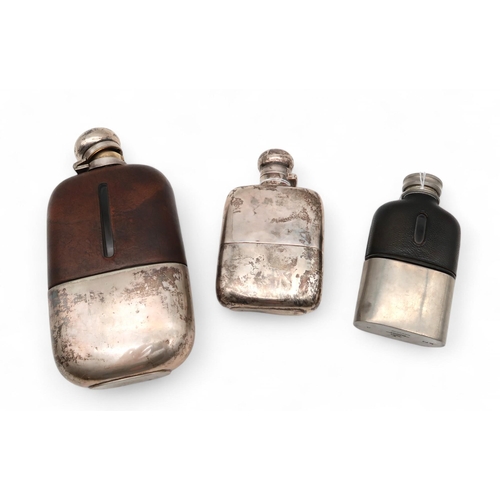 416 - A George V silver hip flask, Birmingham 1931, maker's mark FEC?, and two plated examples, weighable ... 