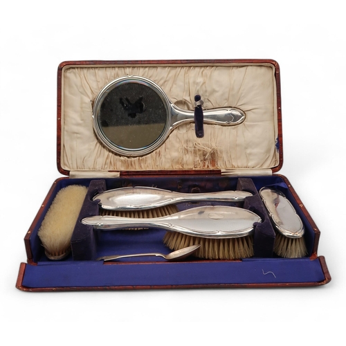 422 - A cased silver dressing set, by Davis, Moss & Co, Birmingham 1929, and a silver spoon, weig... 