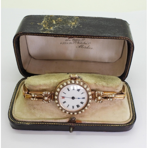 705 - A ladies 9ct gold vintage watch with decorative dial and pearl set bezel and shoulders, case made by... 