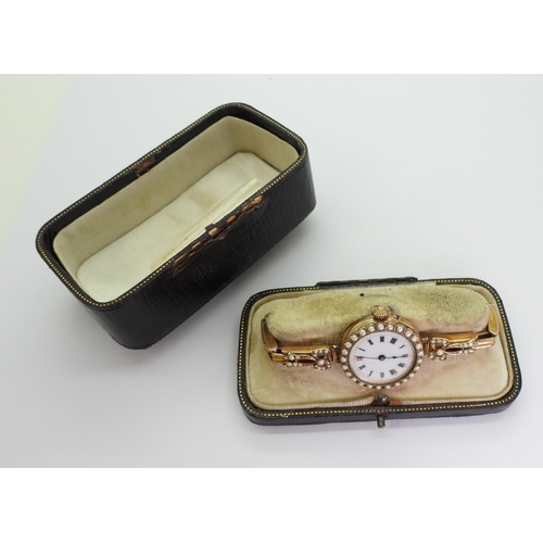 705 - A ladies 9ct gold vintage watch with decorative dial and pearl set bezel and shoulders, case made by... 