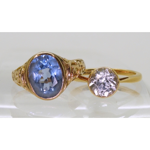 747 - An 18k gold clear gem set ring, size N1/2, weight 3.4gms, together with a 10k gold blue gem set ring... 