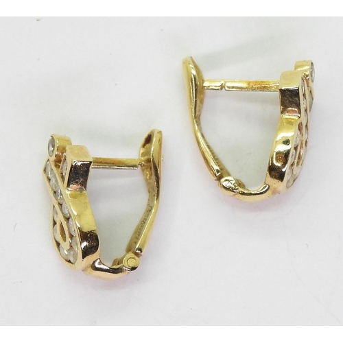 773 - A pair of 14k gold post and clip earrings set with cubic zirconias, weight 3.7gms