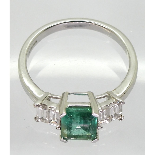 798 - An 18ct white gold classic step cut emerald and baguette cut diamond ring, the emerald measures 7.9m... 