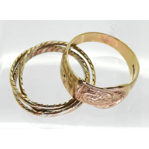 803 - A 9ct gold buckle ring, size O1/2, together with a three colour gold Russian wedding ring size N, we... 