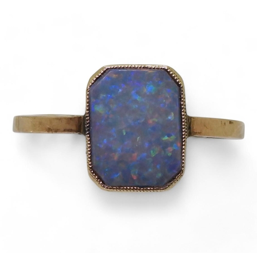 804 - A yellow metal ring set with an opal, size J1/2, weight 1gms