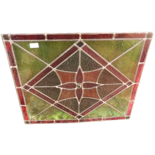 25 - An early 20th century geometric designed leaded stained glass window pane, 63cm x 72cm