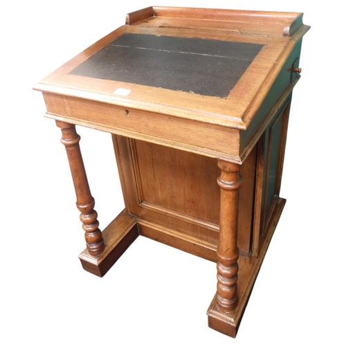 3 - A 19th century oak Davenport writing desk with hinged writing top on base with cabinet door to right... 