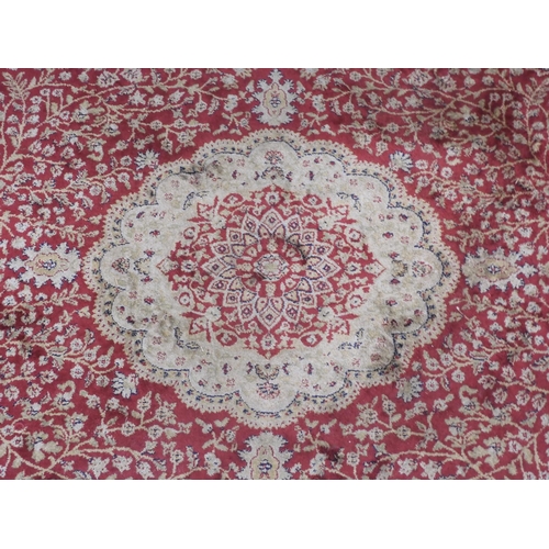 44 - A red ground Kashmiri style Keshan rug with cream central medallion, matching spandrels on foliate p... 