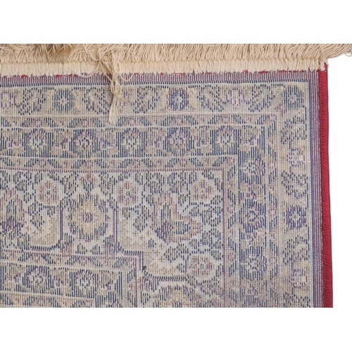 44 - A red ground Kashmiri style Keshan rug with cream central medallion, matching spandrels on foliate p... 