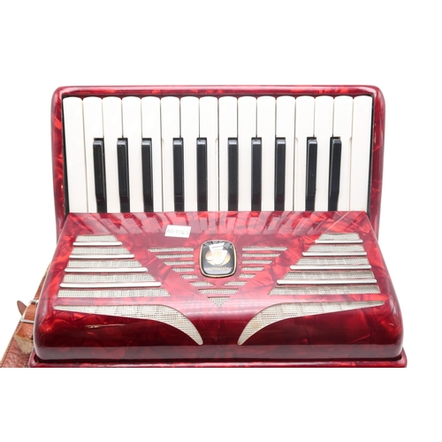 613 - A German made red Worldmaster Piano Accordion, with 26 keys and 32 bass buttons, with case