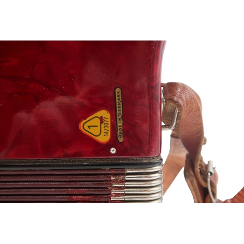 613 - A German made red Worldmaster Piano Accordion, with 26 keys and 32 bass buttons, with case