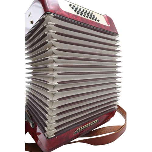 613 - A German made red Worldmaster Piano Accordion, with 26 keys and 32 bass buttons, with case