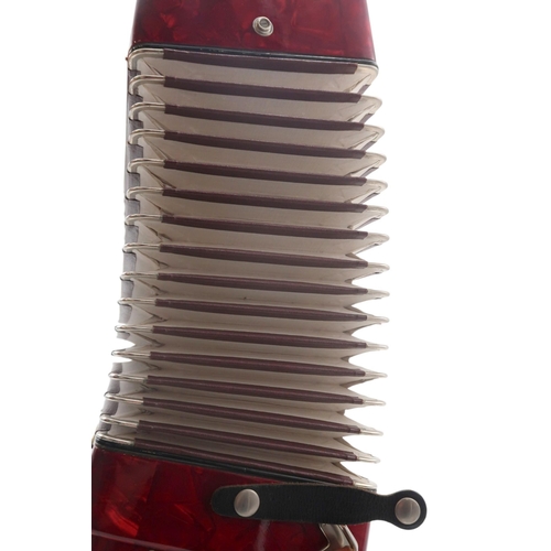 613 - A German made red Worldmaster Piano Accordion, with 26 keys and 32 bass buttons, with case