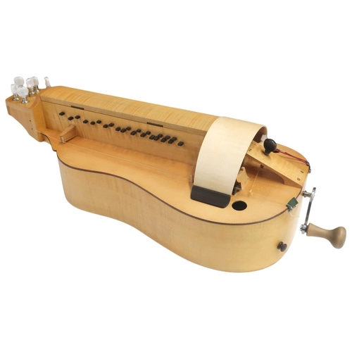 623 - A Contemporary Hurdy-Gurdy, with a flat back and mechanical tuning pegs, with a hard case containing... 