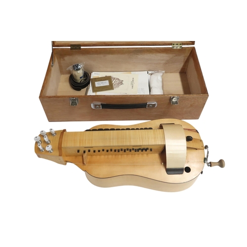 623 - A Contemporary Hurdy-Gurdy, with a flat back and mechanical tuning pegs, with a hard case containing... 